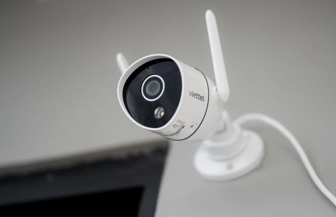A close-up of a modern, sleek home security camera