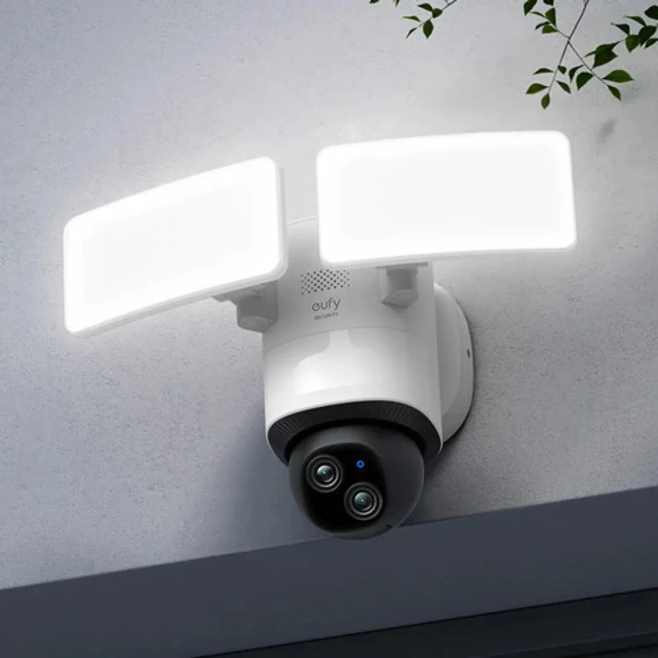 A person installing a home security camera in a garage corner