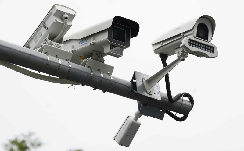 A modern home security camera mounted on a wall